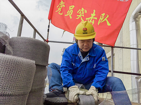 5月10日中午，在動力車間三期工藝除氧器平臺上，黨員突擊隊隊長李鑫正在纏繞新填料.jpg